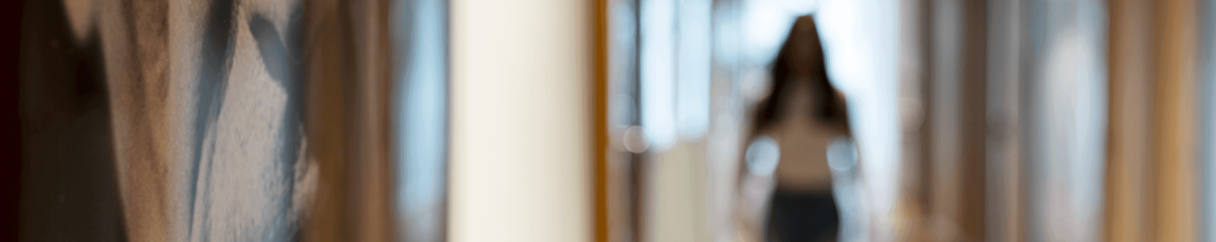 Blurred photo of woman walking through office hallway