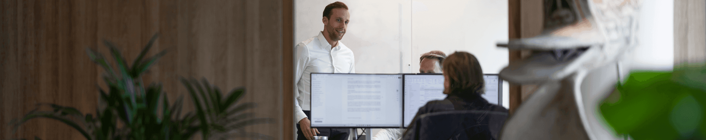 Colleagues meeting with laptops in office room
