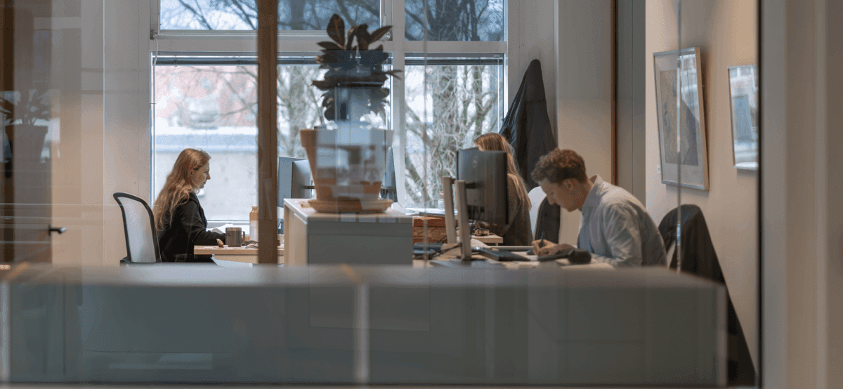 Colleagues working at desks with computers