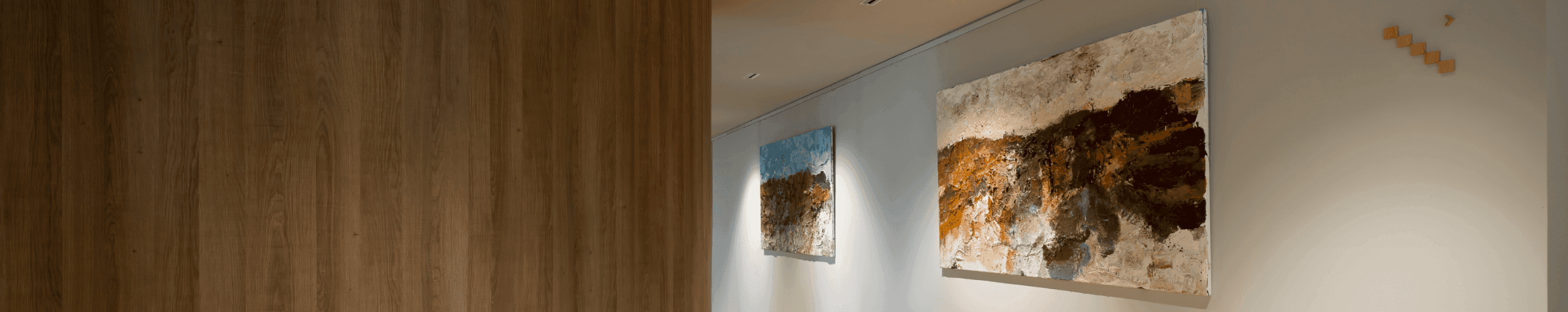 Hallway with wooden floor and two art paintings