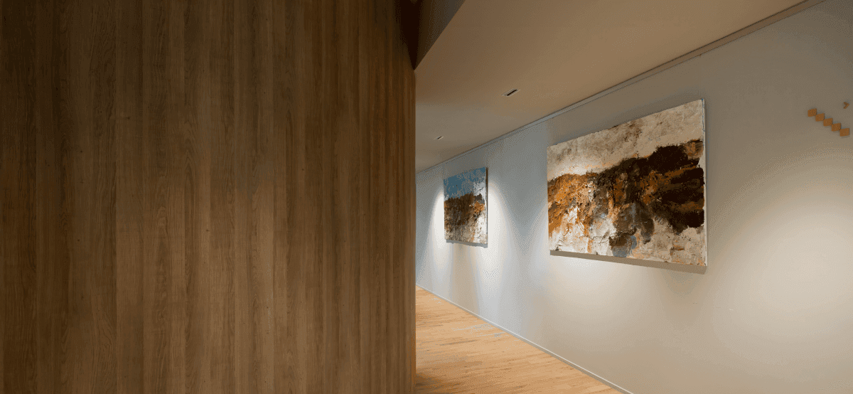Hallway with wooden floor and two art paintings