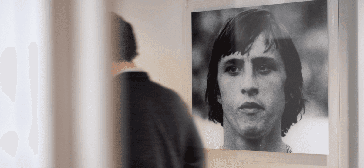 Man looking at black and white portrait in office
