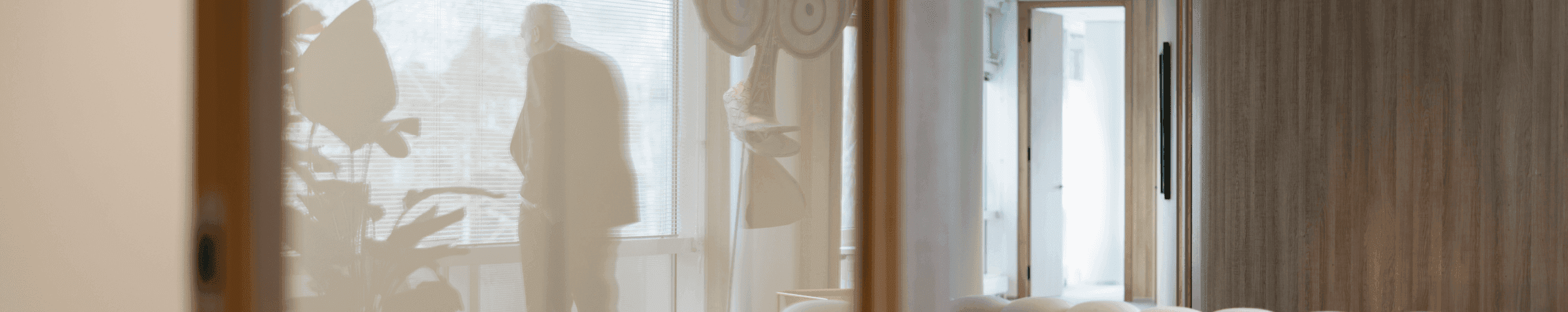 Man standing by window with reflection in office space