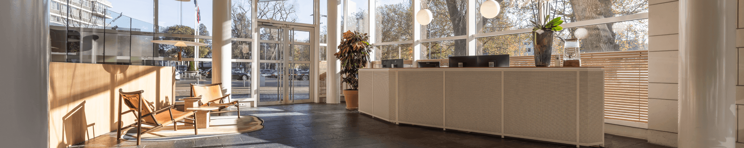 Modern reception with large windows and wooden chairs