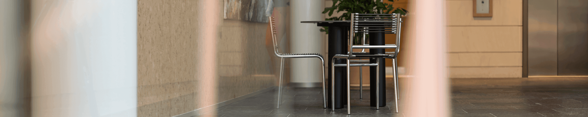 Seating area with black table and chairs near painting